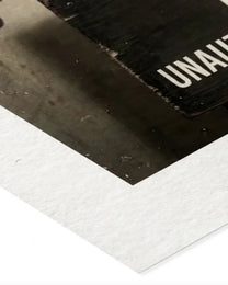 Close-up of the heavyweight matte archival paper edge on a Perp print